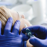 Medical provider preparing to inject Restylane Lyft hyaluronic dermal gel filler into the cheek area.