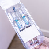 Medical provider holding carton with a 1mL Restylane Refyne syringe, and two needles included.